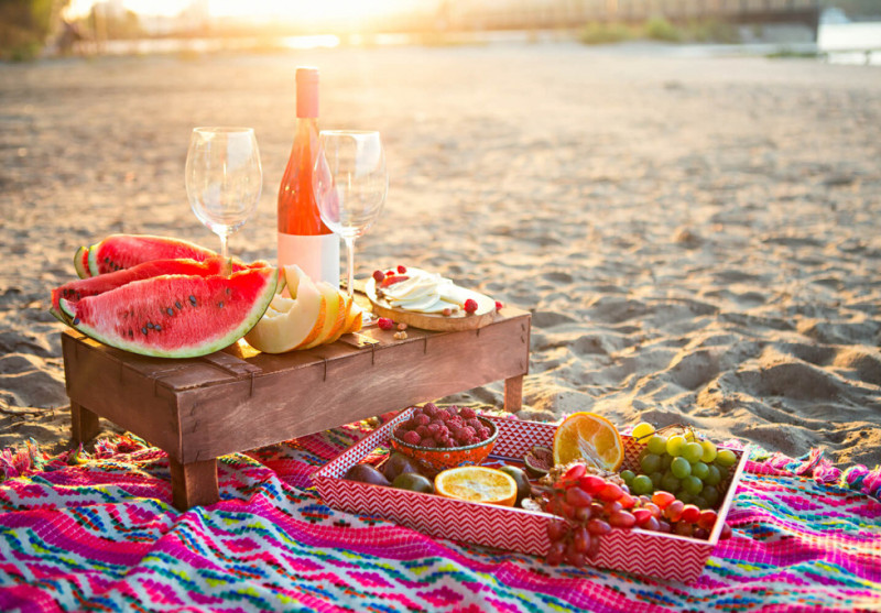 Romantic picnic on the seashore at sunset