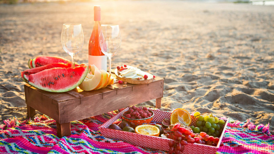 Romantic picnic on the seashore at sunset
